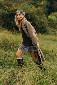 Rear view of woman standing on grassy field