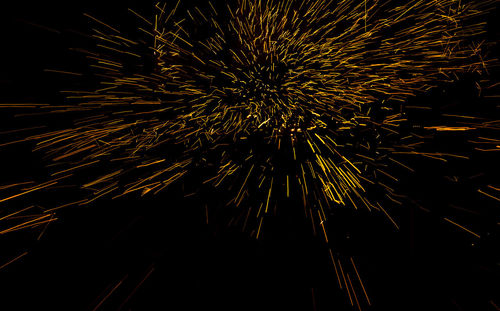 Low angle view of firework display at night