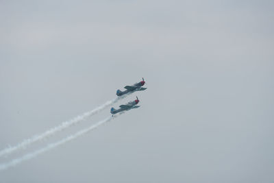 Low angle view of airplane flying against sky