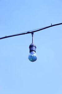 Low angle view of light bulb against clear sky