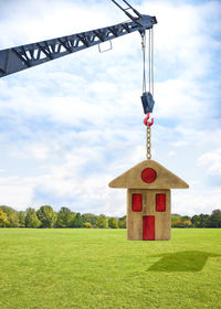 Traditional windmill on field against sky