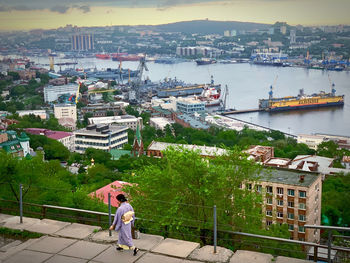 High angle view of people walking amidst buildings in city