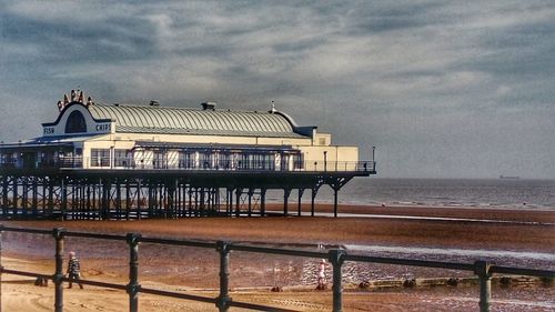 Built structure on beach against sky