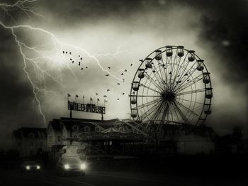 Low angle view of ferris wheel against sky