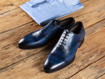 High angle view of shoes on wooden table