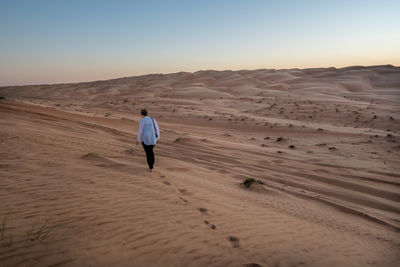 Rear view of man on desert