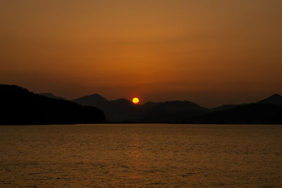 Scenic view of sea against romantic sky at sunset