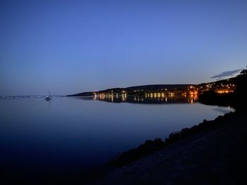 Scenic view of sea against clear blue sky at night