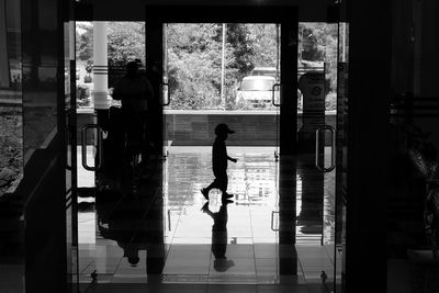 Silhouette men on window