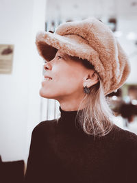 Close-up portrait of young woman looking away