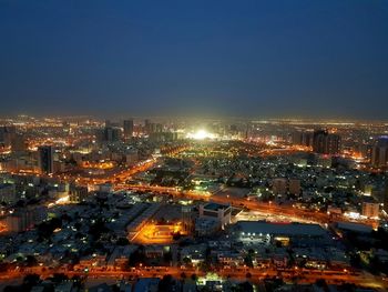 High angle view of illuminated city against sky at night