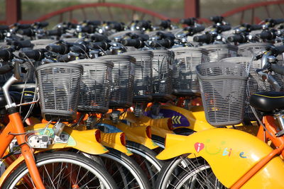 Close-up of yellow bicycles in parking lot