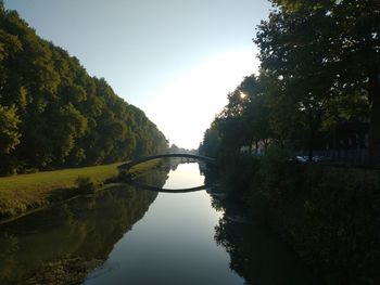 Arch bridge over river against sky