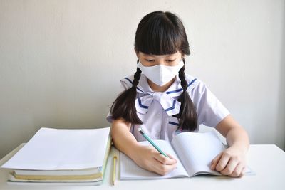 Portrait of smiling young woman sitting on table