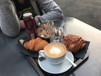 Midsection of person having breakfast at table