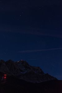 Scenic view of snowcapped mountains against sky at night