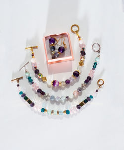 High angle view of multi colored bead on white background