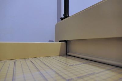 Close-up of tiled floor against wall at home