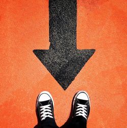 Low section of person standing on tiled floor