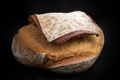 Close-up of bread against black background
