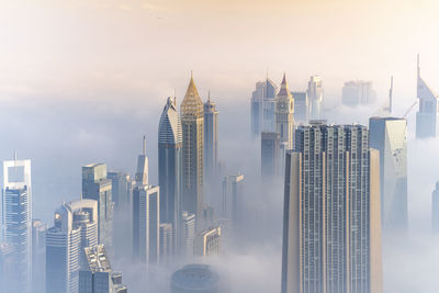 Panoramic view of buildings in city against sky