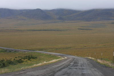 Empty road along landscape