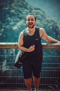 Portrait of smiling young man standing outdoors