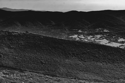 High angle view of land and mountains against sky