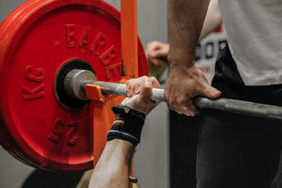 Midsection of man exercising in gym