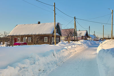 Snow covered field against sky