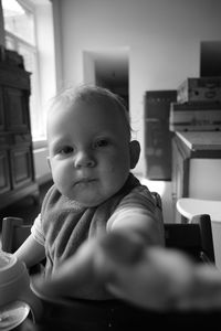 Portrait of cute girl sitting at home