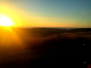 Scenic view of field against sky during sunset