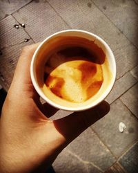 Cropped hand holding coffee cup