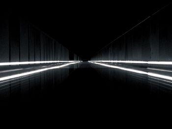 Illuminated tunnel at night