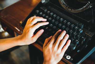 High angle view of person using vintage keyboard