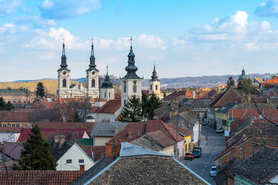 High angle view of buildings in town against sky