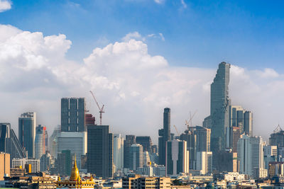 Modern buildings in city against sky