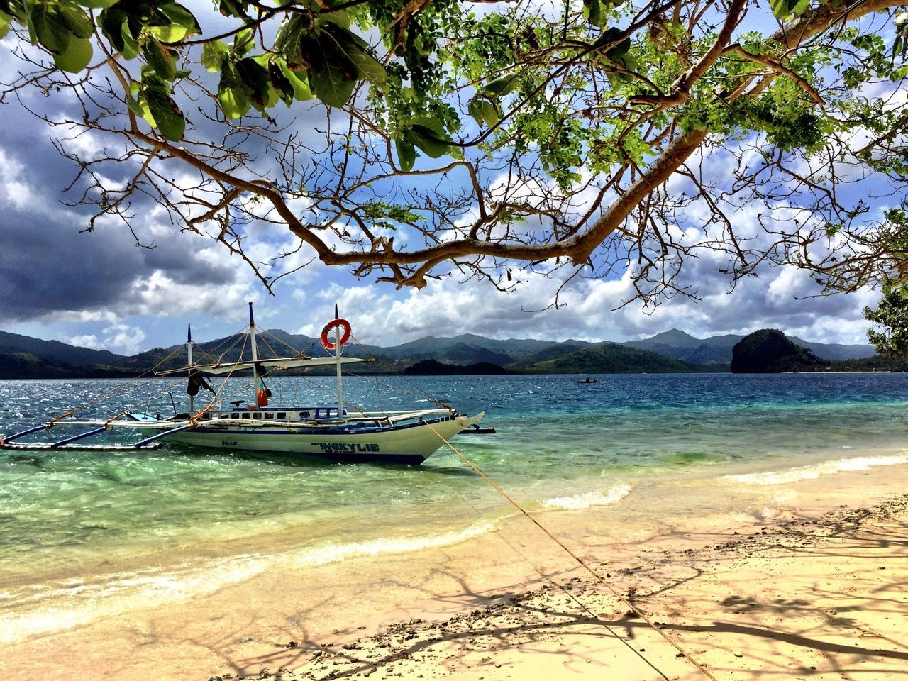 nautical vessel, boat, water, transportation, sky, mode of transport, sea, tree, cloud - sky, moored, tranquility, beach, tranquil scene, nature, scenics, beauty in nature, shore, cloud, cloudy, sand