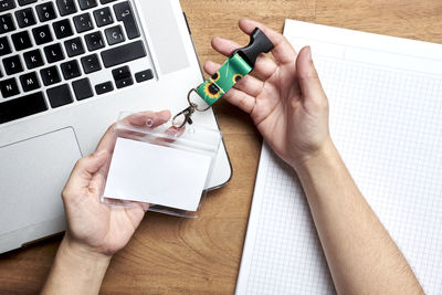 Cropped hands of woman holding key