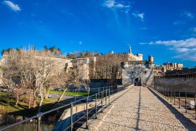 Bridge over canal against blue sky