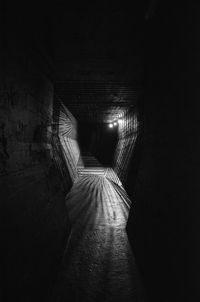 Low angle view of illuminated tunnel at night