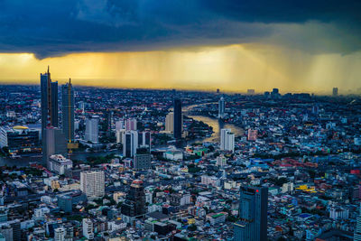 Aerial view of cityscape against sky during sunset