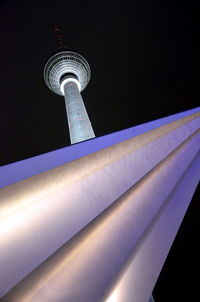 Low angle view of illuminated tower at night