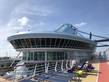 People working on boat against sky