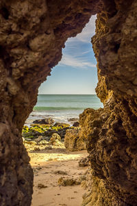 Scenic view of sea and rock formation against sky