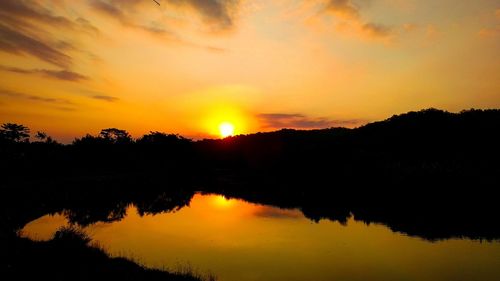 Scenic view of lake against romantic sky at sunset