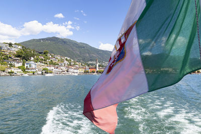 View of flag on mountain against sea