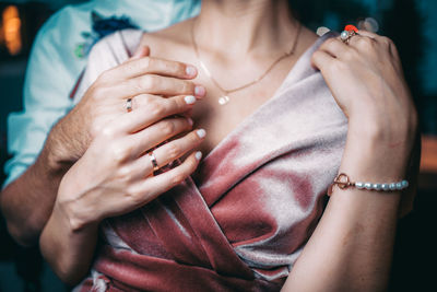 Midsection of woman holding hands