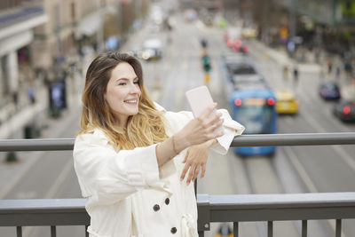 Woman taking selfie with her cell phone