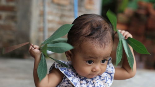 Portrait of cute girl holding outdoors